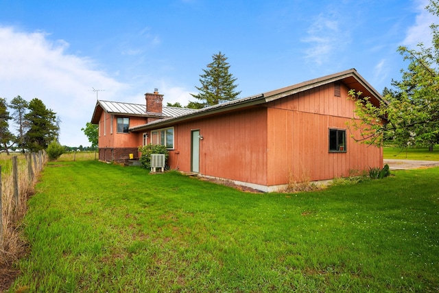 4796 W Gibson Dahl Rd, Clayton, WA 99110 - view of side of property featuring metal roof, a chimney, central AC unit, and a standing seam roof