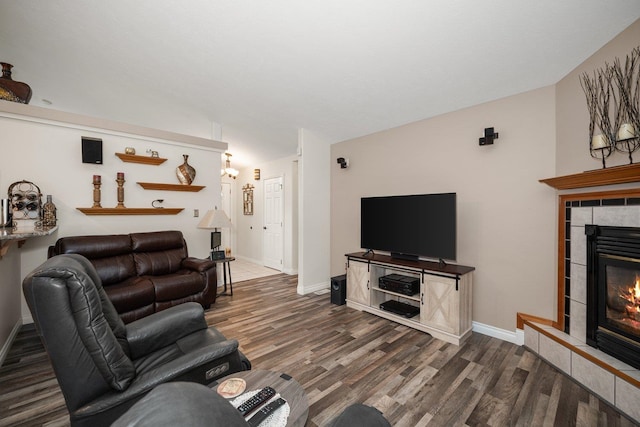 17110 W Boone Ln, Medical Lake, WA 99022 - living room with wood finished floors, a tiled fireplace, baseboards, and vaulted ceiling