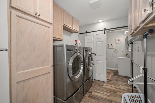 17110 W Boone Ln, Medical Lake, WA 99022 - laundry room featuring separate washer and dryer, cabinet space, a barn door, and dark wood-type flooring