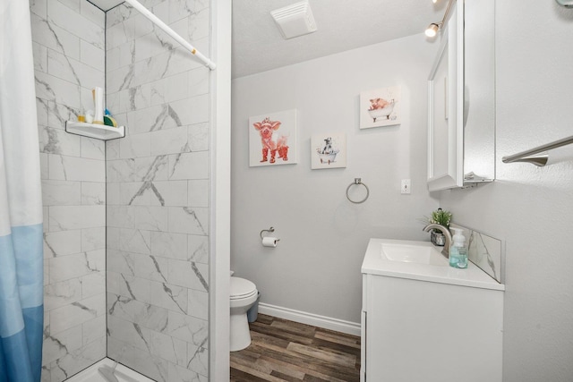 17110 W Boone Ln, Medical Lake, WA 99022 - bathroom with wood finished floors, a stall shower, vanity, toilet, and baseboards