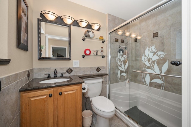 17110 W Boone Ln, Medical Lake, WA 99022 - full bathroom featuring tile walls, toilet, vanity, a stall shower, and a wainscoted wall