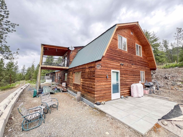 2010 Clemons Rd, Rice, WA 99167 - back of house with a gambrel roof, metal roof, and log exterior
