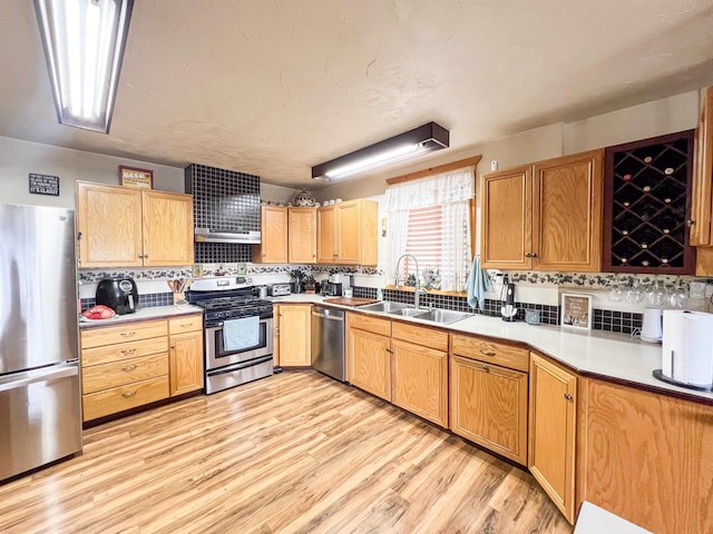 2010 Clemons Rd, Rice, WA 99167 - kitchen with appliances with stainless steel finishes, tasteful backsplash, a sink, and light wood finished floors