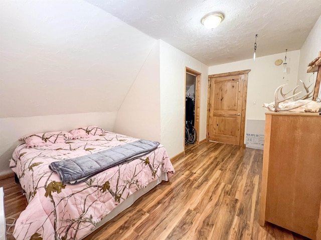 2010 Clemons Rd, Rice, WA 99167 - bedroom with wood finished floors, a textured ceiling, and baseboards