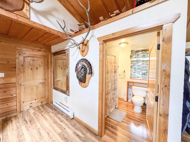 2010 Clemons Rd, Rice, WA 99167 - hallway with a baseboard heating unit and light wood-style floors