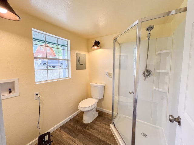2010 Clemons Rd, Rice, WA 99167 - full bathroom with wood finished floors, toilet, a stall shower, and electric panel