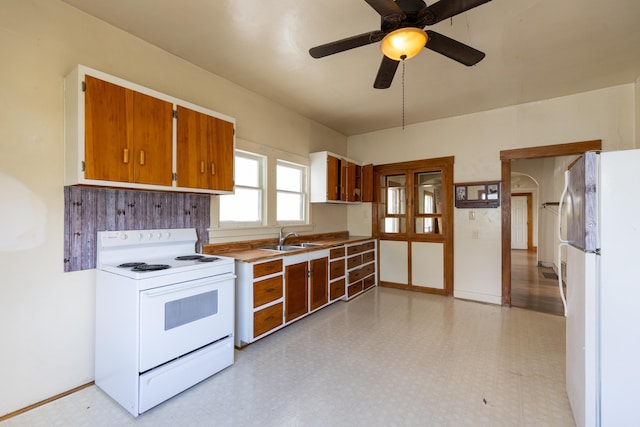 608 S Hatch St, Spokane, WA 99202 - kitchen with white appliances, a sink, light flooring, and brown cabinetry