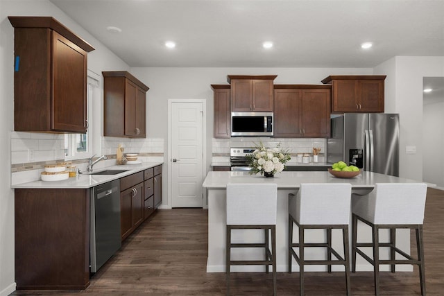 3716 S Keller Ln, Spokane Valley, WA 99206 - kitchen featuring stainless steel appliances, a sink, dark wood-style flooring, decorative backsplash, and recessed lighting