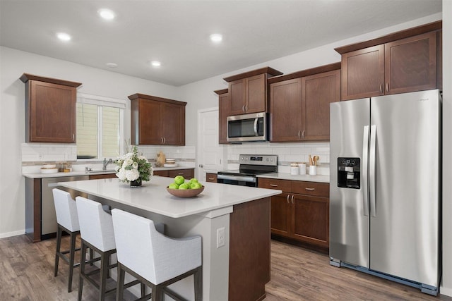 3716 S Keller Ln, Spokane Valley, WA 99206 - kitchen with stainless steel appliances, decorative backsplash, dark wood-type flooring, light countertops, and recessed lighting