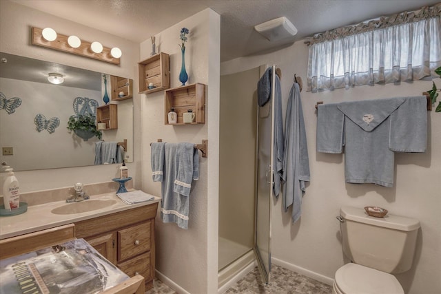 12820 E Sinto Ave, Spokane Valley, WA 99216 - full bathroom featuring toilet, vanity, a shower stall, and baseboards