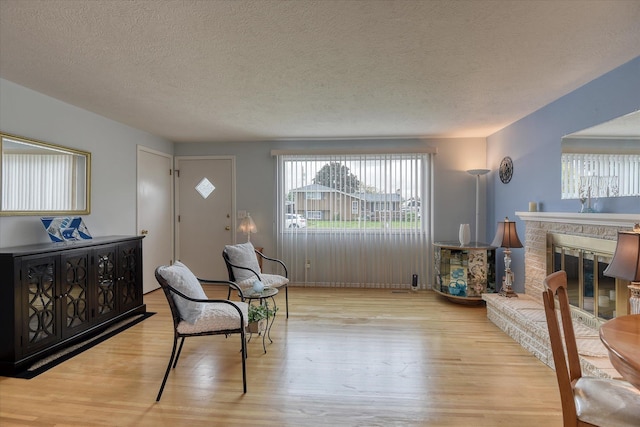 12820 E Sinto Ave, Spokane Valley, WA 99216 - foyer with wood finished floors, a textured ceiling, and a glass covered fireplace