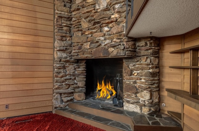 12515 E Apache Pass Rd, Spokane, WA 99206 - detailed view of a stone fireplace, a textured ceiling, carpet flooring, and wood walls