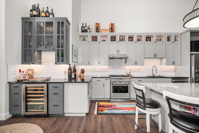 220 E Meadowlane Rd, Spokane, WA 99224 - kitchen featuring wine cooler, high end stainless steel range oven, a sink, dark wood-style flooring, and under cabinet range hood