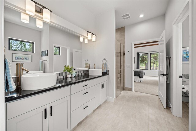 220 E Meadowlane Rd, Spokane, WA 99224 - ensuite bathroom with double vanity, a shower stall, baseboards, tile patterned floors, and recessed lighting