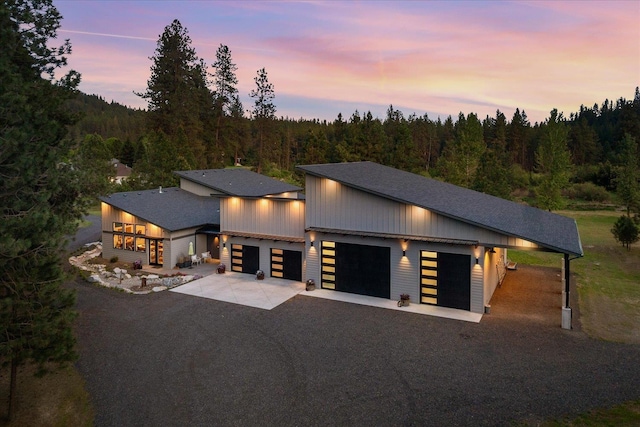 220 E Meadowlane Rd, Spokane, WA 99224 - modern home featuring a view of trees, driveway, and a garage