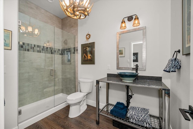 220 E Meadowlane Rd, Spokane, WA 99224 - bathroom with a chandelier, toilet, wood finished floors, a shower stall, and baseboards