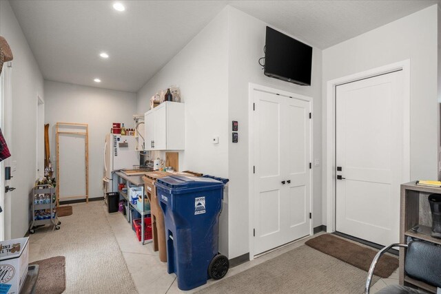 220 E Meadowlane Rd, Spokane, WA 99224 - kitchen with recessed lighting, white cabinetry, light carpet, freestanding refrigerator, and baseboards