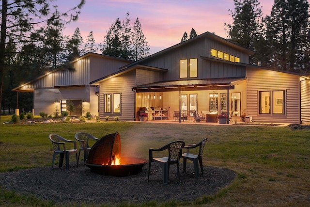 220 E Meadowlane Rd, Spokane, WA 99224 - rear view of house with an outdoor fire pit, a lawn, a patio, and board and batten siding