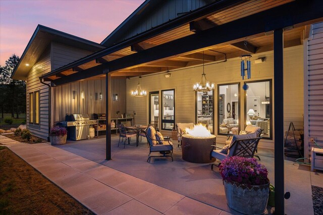 220 E Meadowlane Rd, Spokane, WA 99224 - patio terrace at dusk featuring a fire pit, grilling area, and a patio