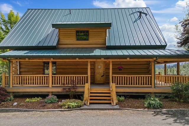 18109 N Harvard Ln, Newman Lake, WA 99025 - cabin featuring covered porch, log siding, metal roof, and a standing seam roof