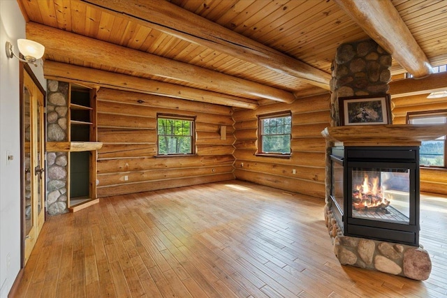 18109 N Harvard Ln, Newman Lake, WA 99025 - unfurnished living room featuring a multi sided fireplace, hardwood / wood-style floors, wood ceiling with exposed beams, and rustic walls
