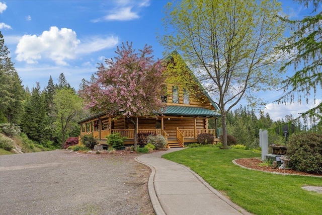 18109 N Harvard Ln, Newman Lake, WA 99025 - cabin featuring covered porch, a front yard, metal roof, and log exterior