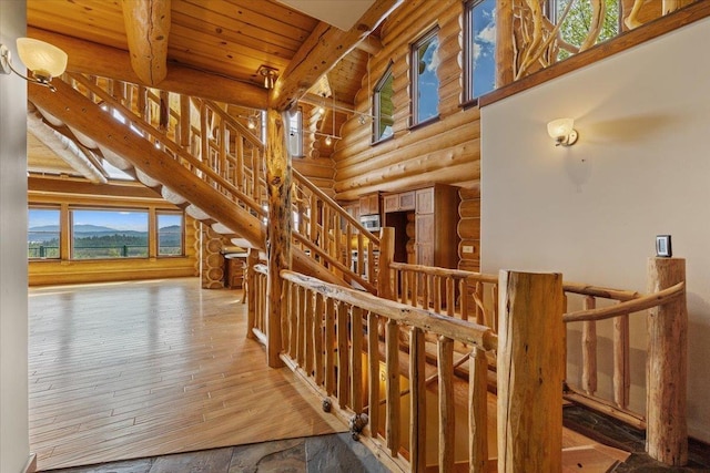 18109 N Harvard Ln, Newman Lake, WA 99025 - additional living space with rustic walls, wood ceiling with exposed beams, hardwood / wood-style flooring, plenty of natural light, and ceiling fan