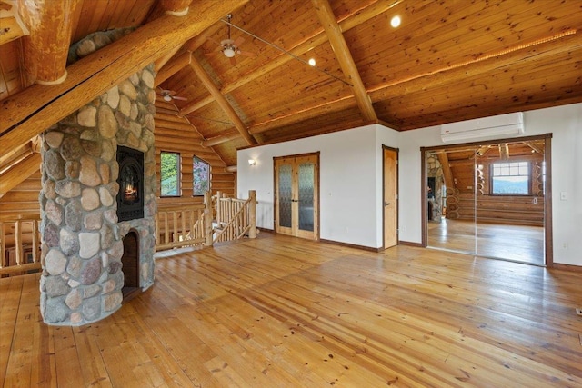 18109 N Harvard Ln, Newman Lake, WA 99025 - unfurnished living room with a wall mounted air conditioner, wooden ceiling with exposed beams, hardwood / wood-style flooring, a fireplace, and baseboards