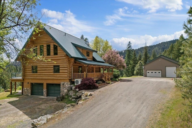 18109 N Harvard Ln, Newman Lake, WA 99025 - view of front of property featuring log exterior, stone siding, a porch, metal roof, and a wooded view