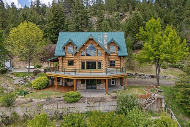 18109 N Harvard Ln, Newman Lake, WA 99025 - back of house featuring log exterior, a wooden deck, a patio area, and a chimney