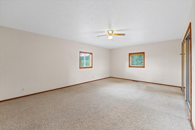 18109 N Harvard Ln, Newman Lake, WA 99025 - spare room featuring ceiling fan, light colored carpet, and baseboards