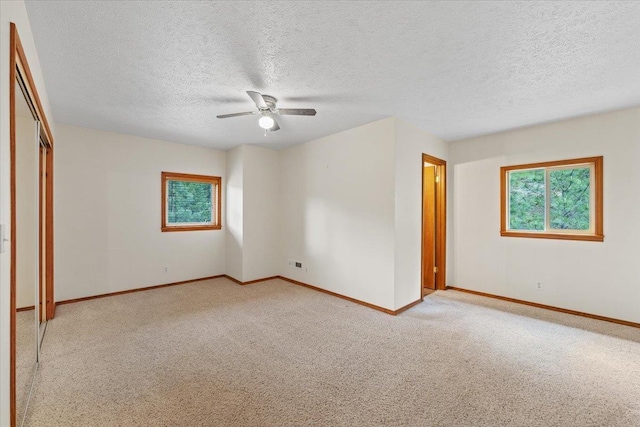 18109 N Harvard Ln, Newman Lake, WA 99025 - unfurnished bedroom featuring baseboards, carpet flooring, a textured ceiling, ceiling fan, and a closet