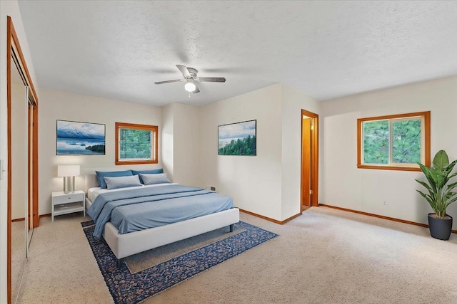 18109 N Harvard Ln, Newman Lake, WA 99025 - carpeted bedroom featuring baseboards, a textured ceiling, ceiling fan, and a closet
