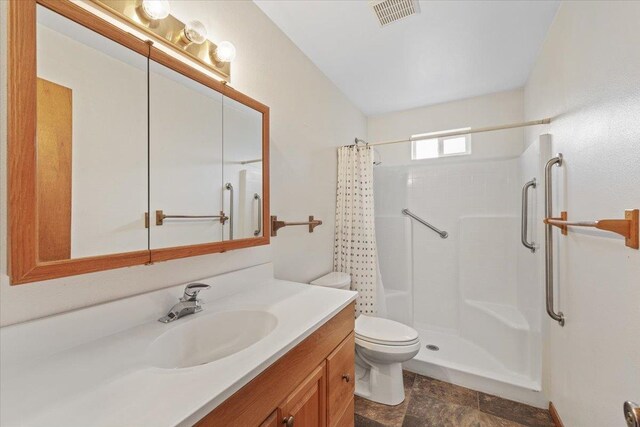 18109 N Harvard Ln, Newman Lake, WA 99025 - full bathroom featuring toilet, a shower with shower curtain, vanity, and stone finish flooring