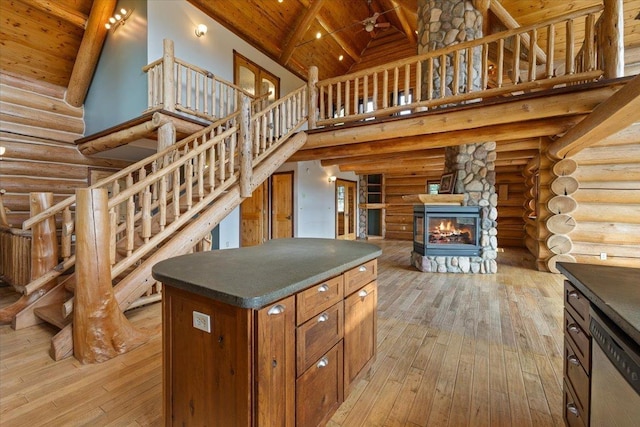 18109 N Harvard Ln, Newman Lake, WA 99025 - kitchen featuring high vaulted ceiling, dishwasher, wooden ceiling with exposed beams, rustic walls, and light wood finished floors