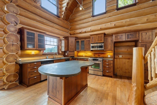 18109 N Harvard Ln, Newman Lake, WA 99025 - kitchen featuring high vaulted ceiling, dishwasher, wooden ceiling with exposed beams, rustic walls, and light wood finished floors