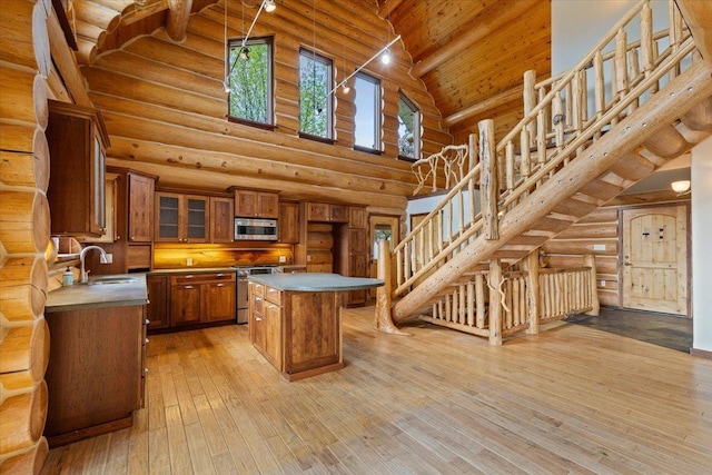 18109 N Harvard Ln, Newman Lake, WA 99025 - dining space with log walls, a chandelier, light wood-style floors, and a mountain view
