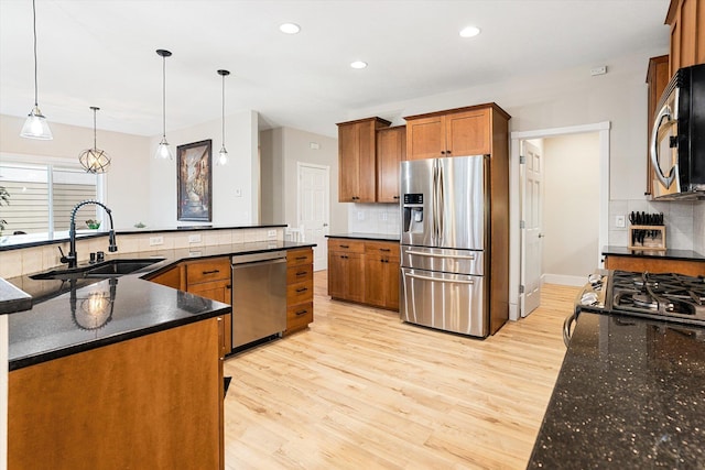 3515 W Excell Ln, Spokane, WA 99208 - kitchen featuring stainless steel appliances, a sink, brown cabinetry, backsplash, and recessed lighting