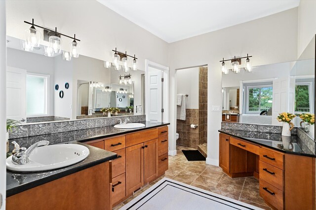 3515 W Excell Ln, Spokane, WA 99208 - bathroom featuring vanity, a tile shower, toilet, and tile patterned flooring