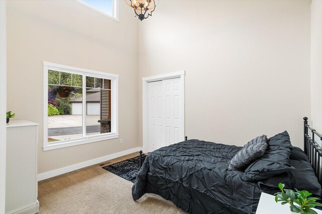 3515 W Excell Ln, Spokane, WA 99208 - bedroom with carpet flooring, multiple windows, a chandelier, a towering ceiling, and baseboards