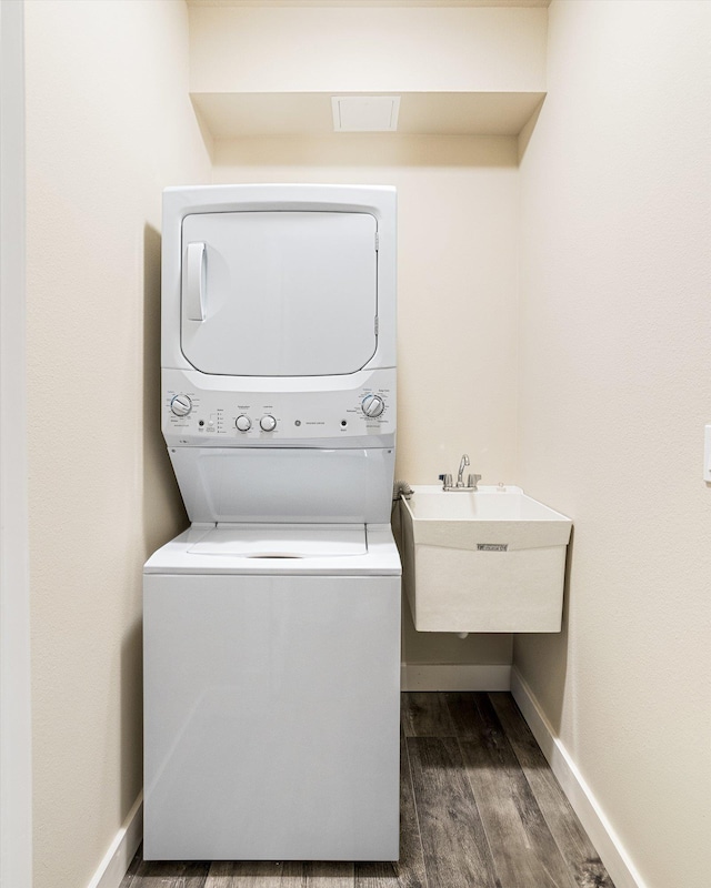 3515 W Excell Ln, Spokane, WA 99208 - washroom with stacked washer and clothes dryer, dark wood-style flooring, and baseboards