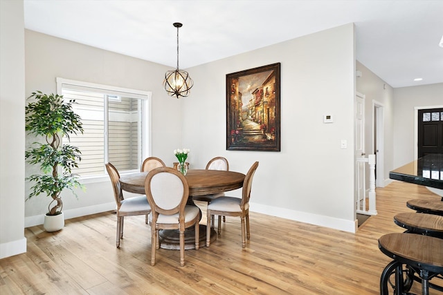 3515 W Excell Ln, Spokane, WA 99208 - dining room with baseboards, light wood finished floors, and a chandelier