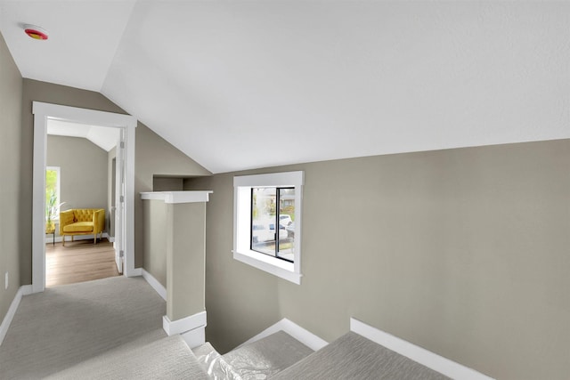 2121 W Sharp Ave, Spokane, WA 99201 - hall featuring vaulted ceiling, an upstairs landing, carpet flooring, and baseboards