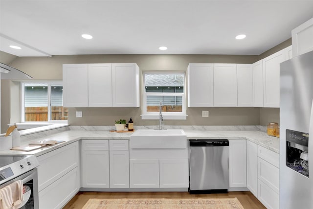 2121 W Sharp Ave, Spokane, WA 99201 - kitchen featuring stainless steel appliances, a sink, white cabinetry, and recessed lighting