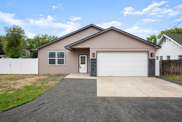 11911 N Main St, Mead, WA 99021 - view of front of home featuring concrete driveway, a garage, and stone siding