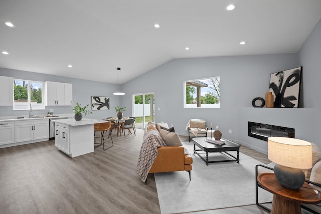 11911 N Main St, Mead, WA 99021 - living room with light wood-style floors, healthy amount of natural light, recessed lighting, lofted ceiling, and a glass covered fireplace