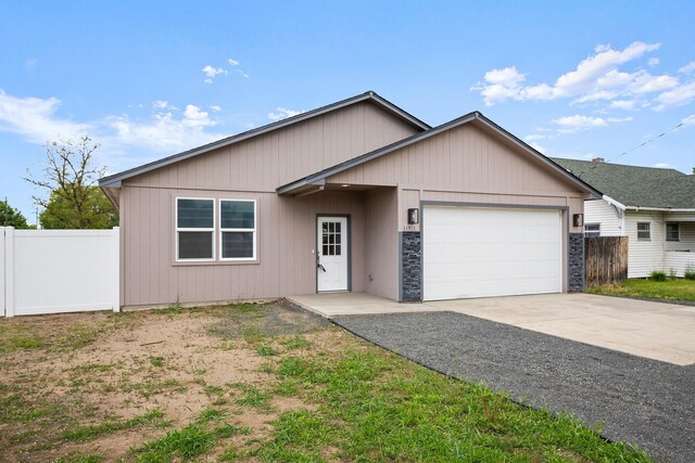 11911 N Main St, Mead, WA 99021 - ranch-style house with an attached garage, concrete driveway, and stone siding