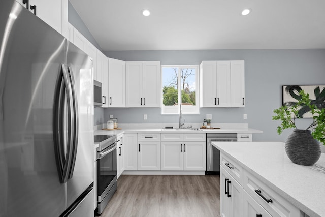 11911 N Main St, Mead, WA 99021 - kitchen featuring appliances with stainless steel finishes, a sink, light wood finished floors, light countertops, and recessed lighting