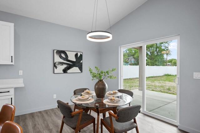 11911 N Main St, Mead, WA 99021 - dining room featuring light wood-style flooring, lofted ceiling, and baseboards