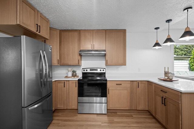 5727 N Cannon St, Spokane, WA 99205 - kitchen with stainless steel appliances, under cabinet range hood, a peninsula, light countertops, and a textured ceiling